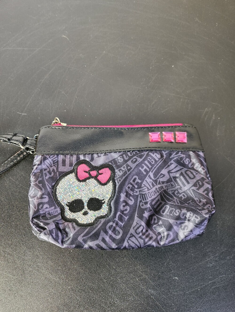 Monster High wristlet purse with a Metallic skull graphic
